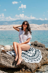 Portrait of beautiful young woman in beach clothes sunbathing on summer vacation.