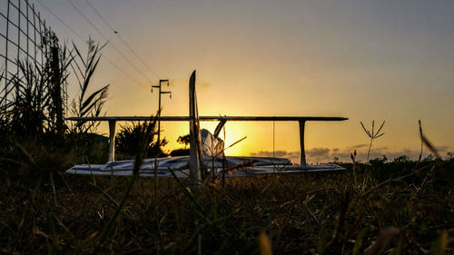 Scenic view of grass against sky during sunset