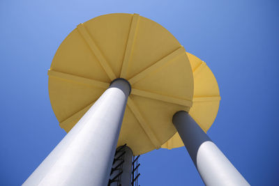 Low angle view of windmill against blue sky