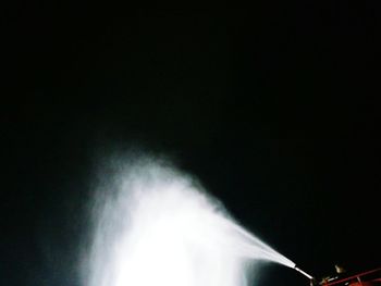 Low angle view of illuminated lighting against sky at night