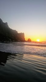 Scenic view of sea against clear sky during sunset