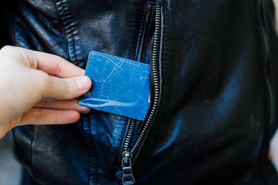 Midsection of man holding wallet