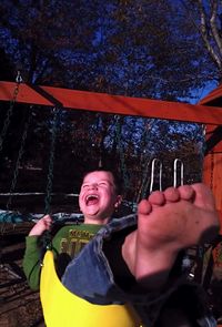 Portrait of a smiling boy in swing