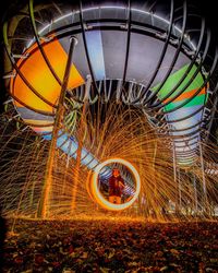 Illuminated ferris wheel at night