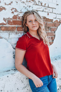 Portrait of beautiful woman against wall