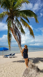 Full length of woman standing at beach