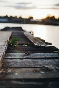 Surface level of pier over lake against sky