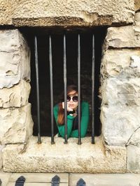 Portrait of woman seen through window