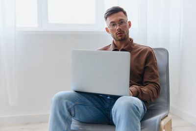 Young man using laptop at home