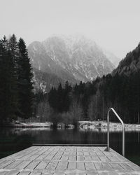 Scenic view of lake by mountains against clear sky