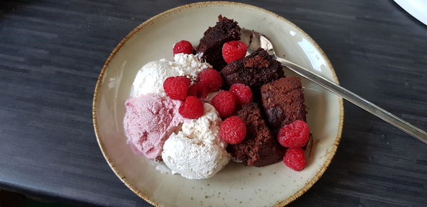 Warm chocolate cake with ice cream and raspberries