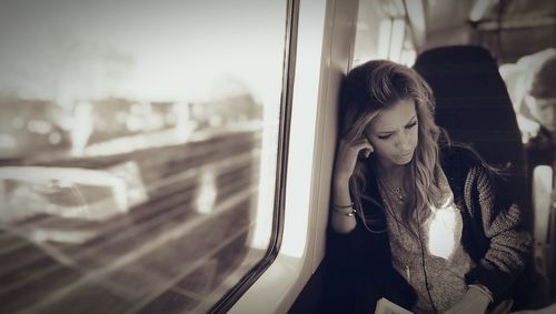 Woman looking down while sitting in train