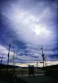 Silhouette of trees against cloudy sky