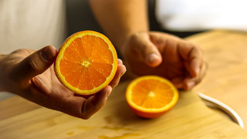 Cropped hand holding lemon