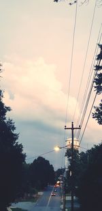 Cars on road against sky during sunset