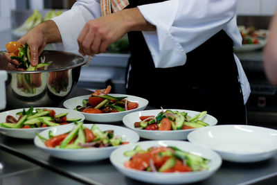 Midsection of chef preparing food in kitchen