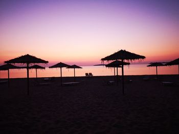 Scenic view of beach against clear sky during sunset