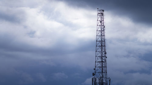 Low angle view of communications tower against sky