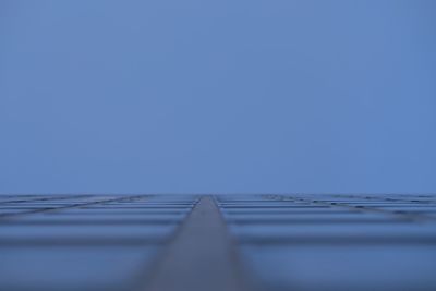 Surface level of table against clear blue sky