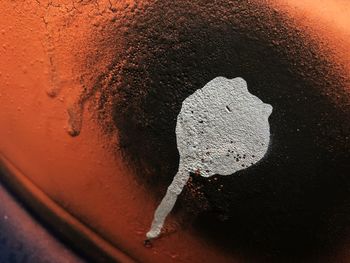 High angle view of water drops on rusty metal