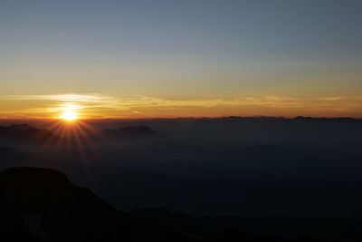 Scenic view of silhouette mountains against sky during sunset