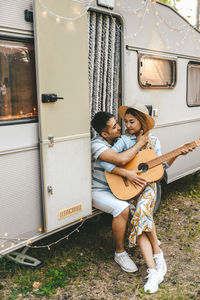 Married asian couple in love travel by camper car on a road trip in nature on their honeymoon