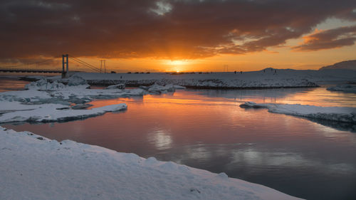 Scenic view of frozen sea against orange sky