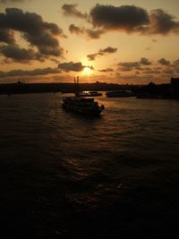 View of boats in sea at sunset