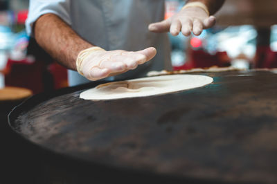 Close-up of man preparing food