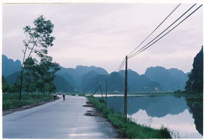 Scenic view of river against cloudy sky