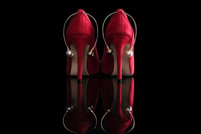Close-up of red shoes against black background