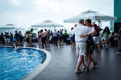 Group of people walking in swimming pool