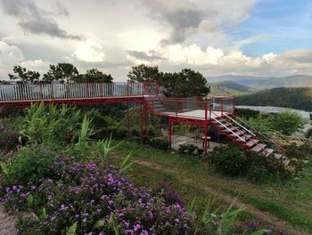 Bridge over field against sky