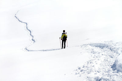 Rear view of woman on snowcapped mountain