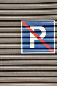 No parking sign on corrugated iron