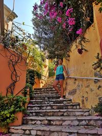 Low angle view of person on steps by building