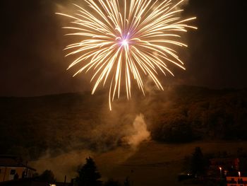 Low angle view of firework display at night