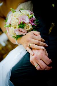 Close-up of hand holding rose bouquet