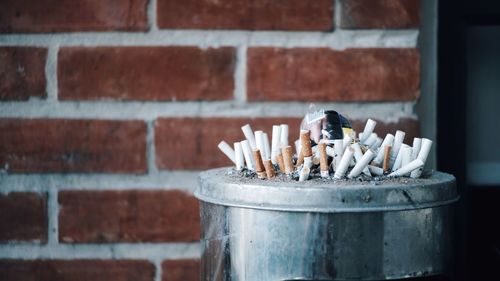 Close-up of cigarette against the wall