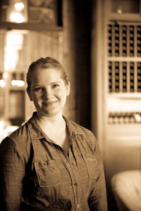 Portrait of beautiful woman standing in winery