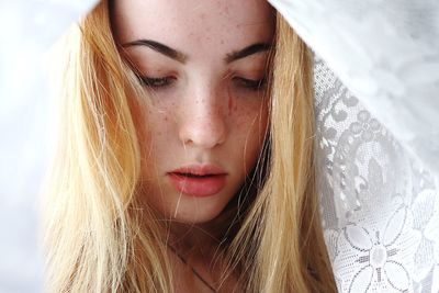 Close-up of beautiful woman with blond hair under scarf