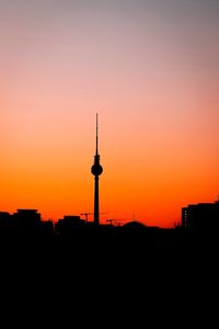 Silhouette of buildings against sky during sunset