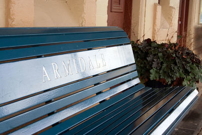 High angle view of text on bench against wall