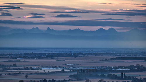 Aerial view of city against sky at sunset