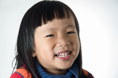 Portrait of smiling boy against white background
