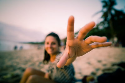 Portrait of young woman against sky