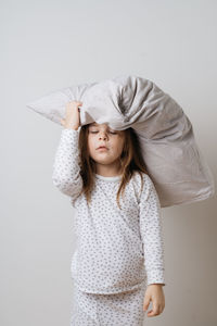 Portrait of girl wearing hat against white background