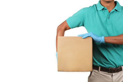 Midsection of man holding umbrella against white background