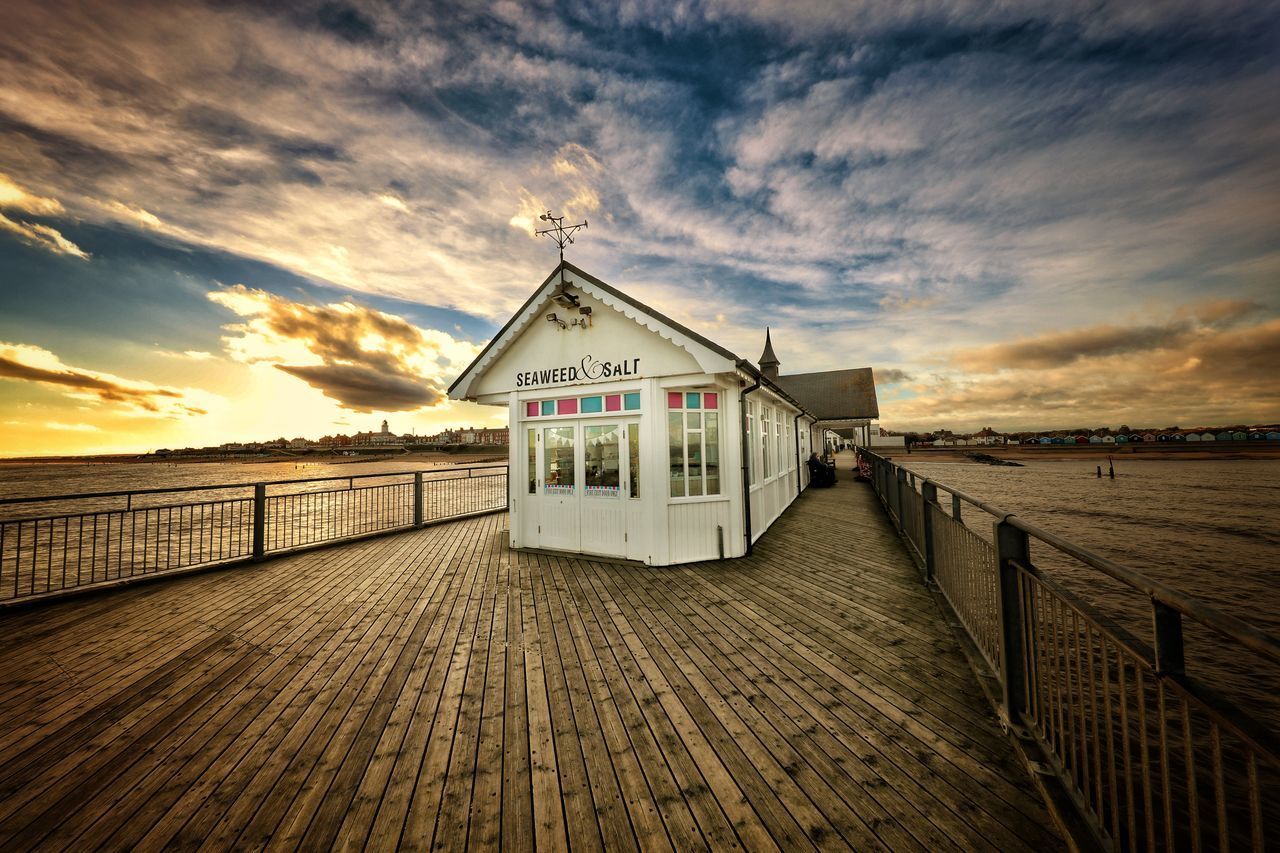 LIFEGUARD HUT ON BEACH AGAINST SKY