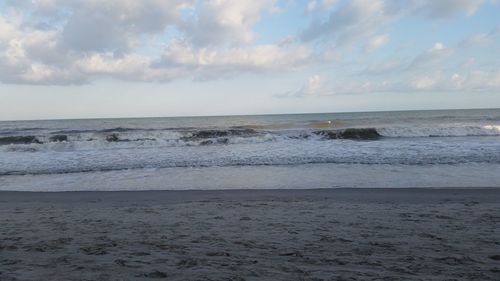 Scenic view of sea against cloudy sky